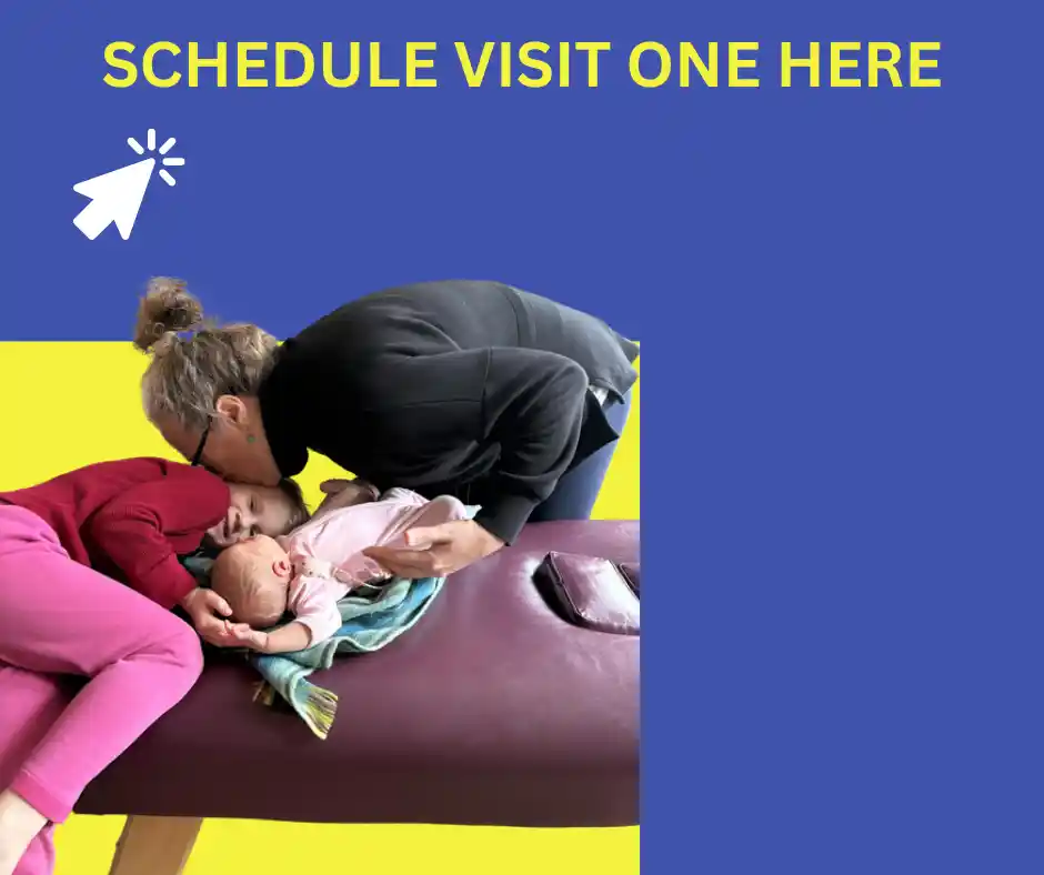 A caregiver is kissing a child while holding a baby on a treatment table. Text above reads "SCHEDULE VISIT ONE HERE" with a clickable cursor symbol. The background is split between blue and yellow.